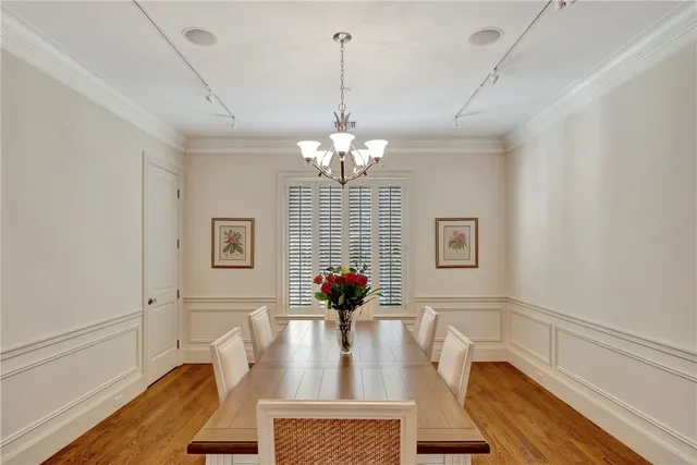 a view of a dining room with furniture and chandelier