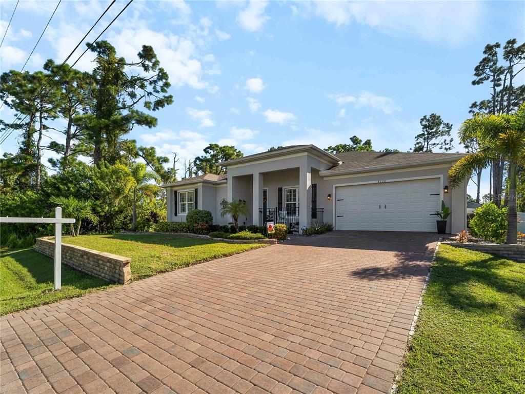 8228 Walbert Street Port Charlotte, FL 33981 - Photo 4 of 66 a front view of a house with a yard and potted plants