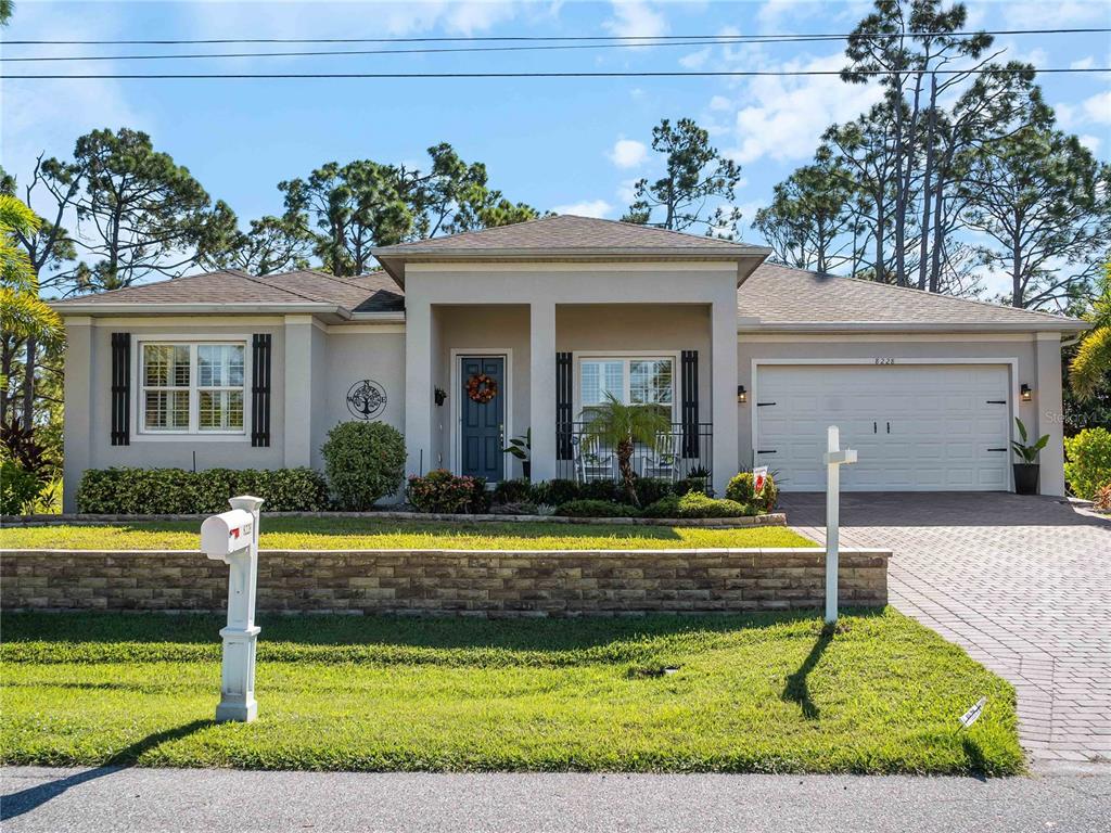 8228 Walbert Street Port Charlotte, FL 33981 - Photo 5 of 66 a front view of a house with a yard
