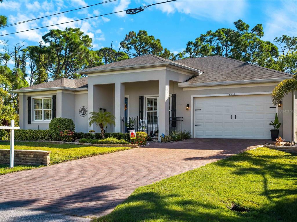 8228 Walbert Street Port Charlotte, FL 33981 - Photo 6 of 66 a view of a house with swimming pool and a yard