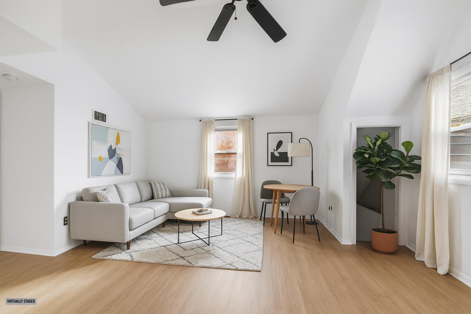 a living room with furniture and a potted plant