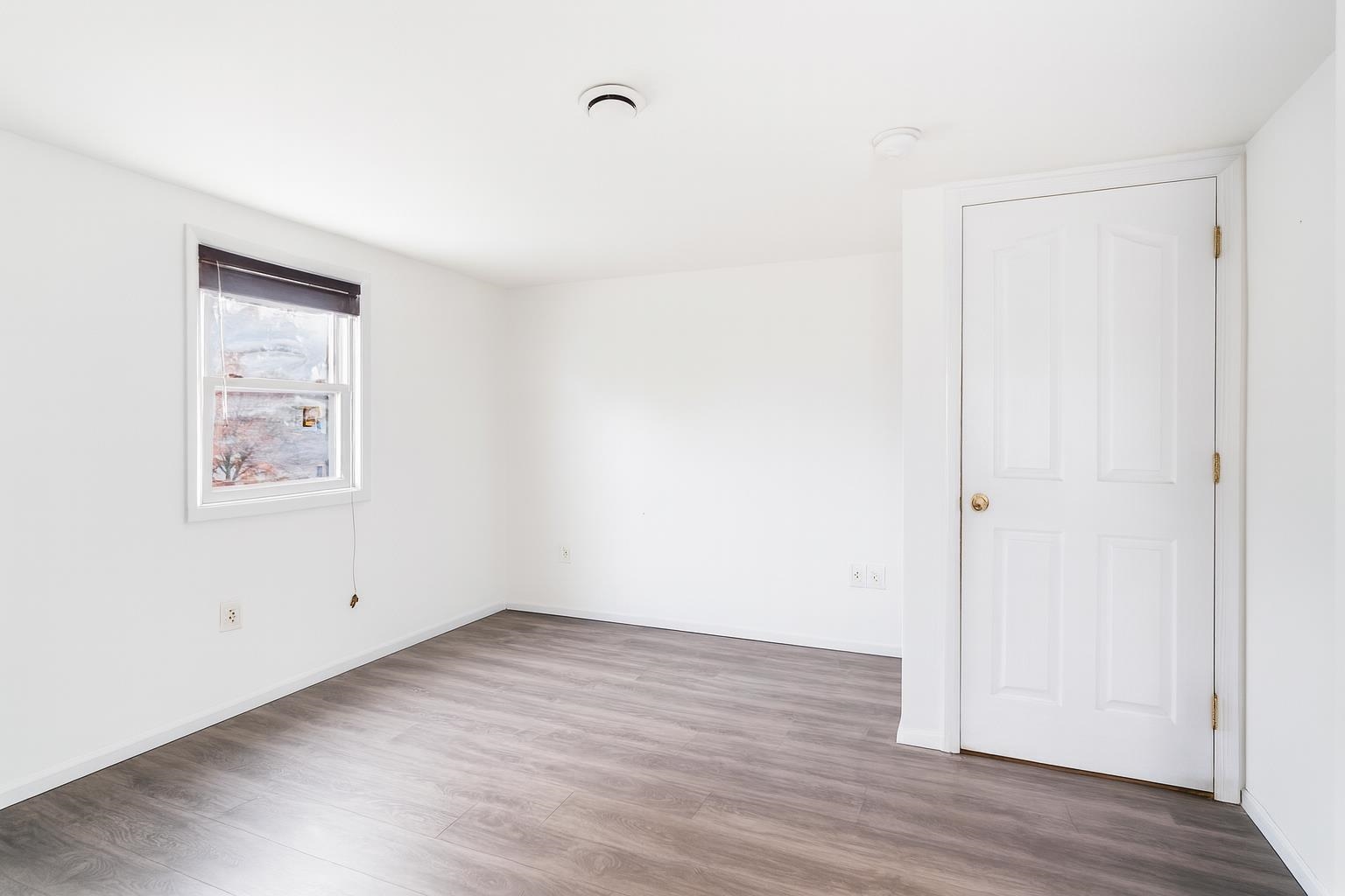 689 2nd Street, Unit 2 Secaucus, NJ 07094 - Photo 11 of 22 an empty room with wooden floor and white walls