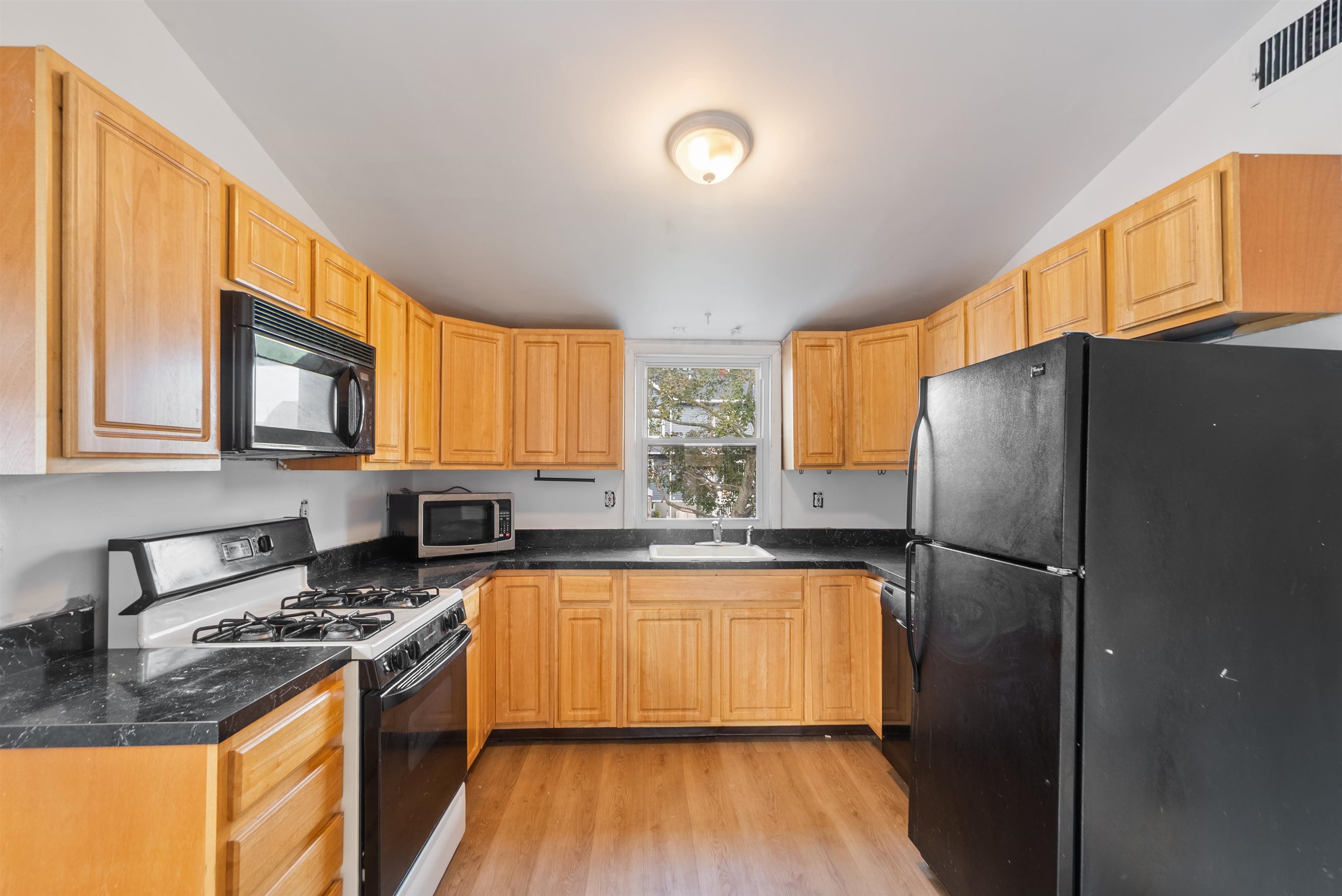 689 2nd Street, Unit 2 Secaucus, NJ 07094 - Photo 7 of 22 a kitchen with a refrigerator a sink and a stove top oven