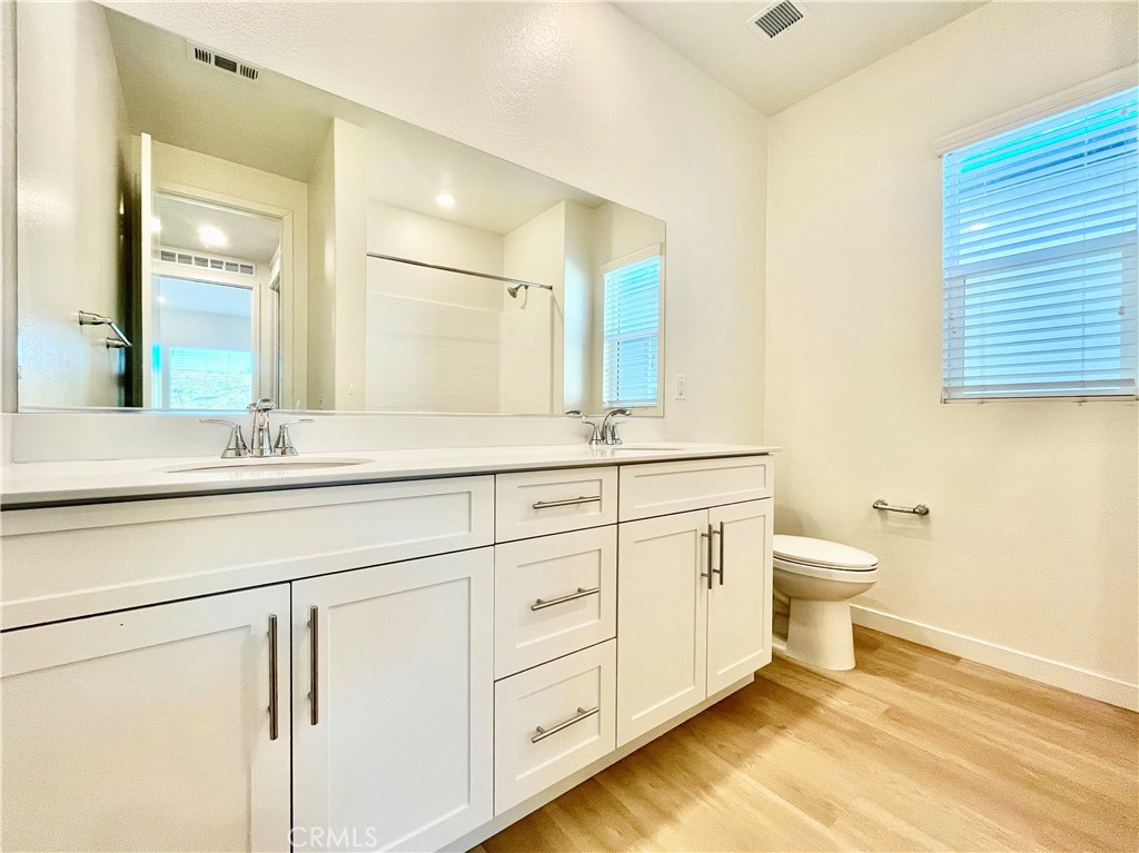 27237 Release Place Newhall, CA 91381 - Photo 21 of 23 a bathroom with a double vanity sink a toilet and a mirror