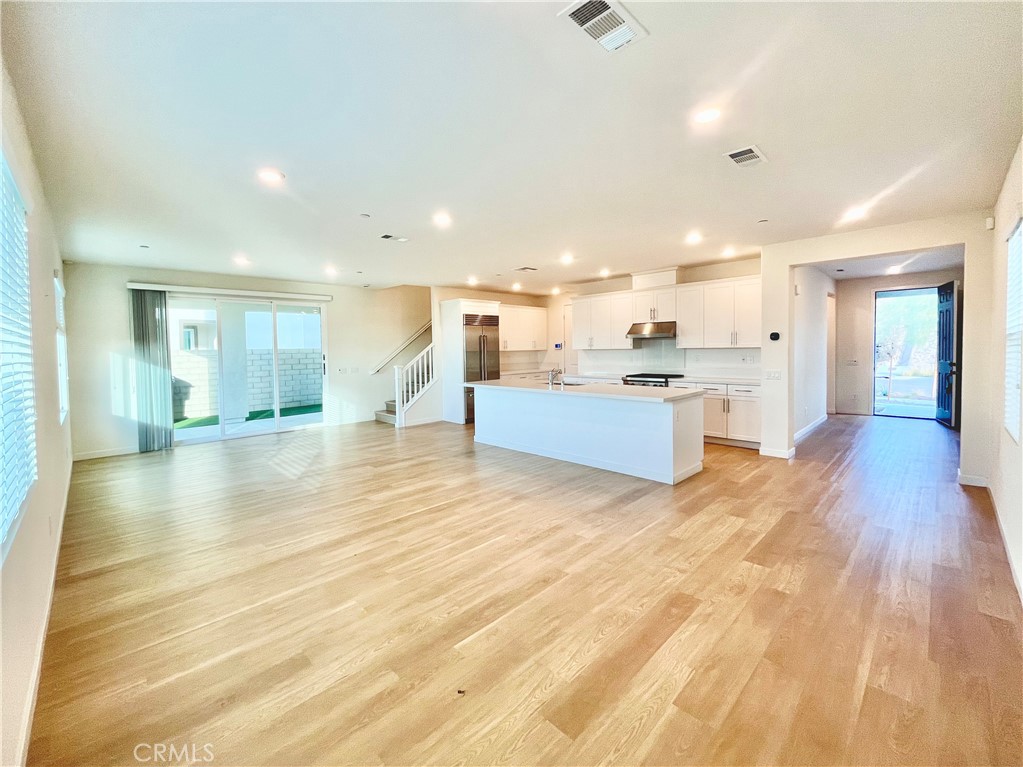 27237 Release Place Newhall, CA 91381 - Photo 5 of 23 a view of a kitchen with kitchen island wooden floors wooden cabinets and counter space