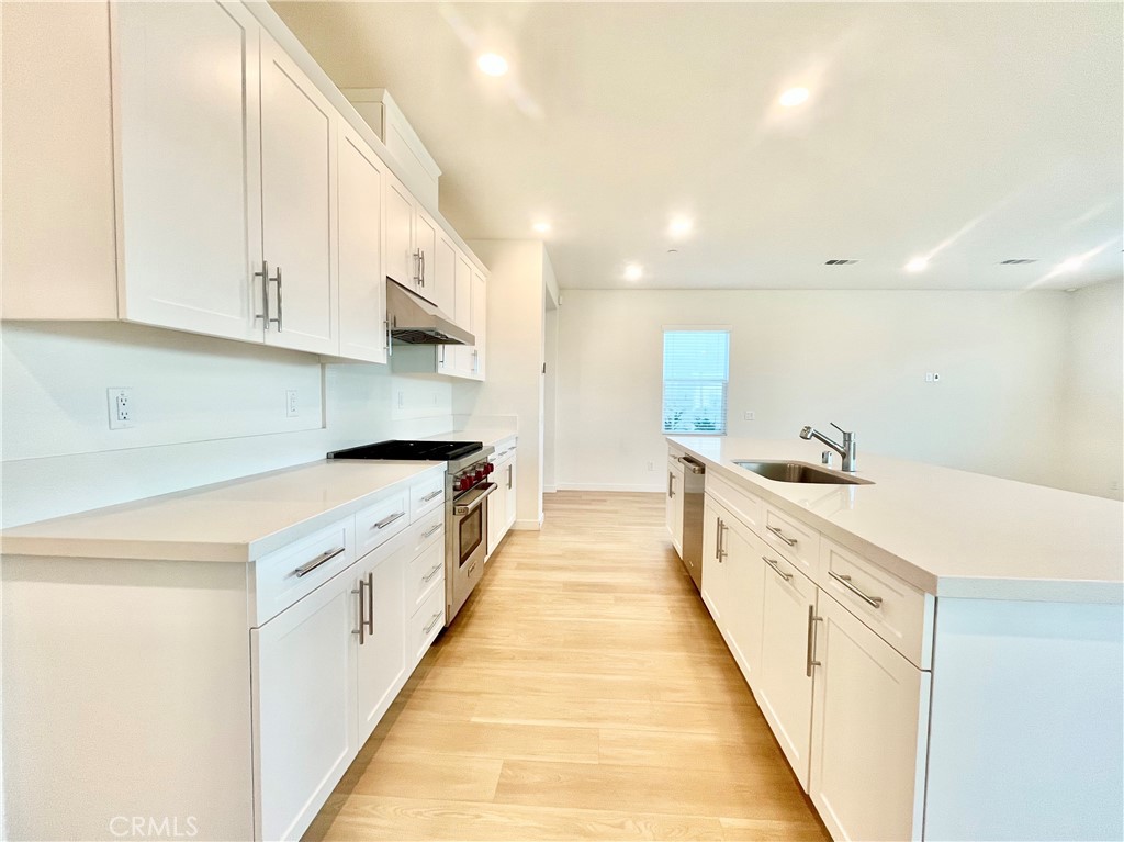 27237 Release Place Newhall, CA 91381 - Photo 7 of 23 a large white kitchen with cabinets and a sink