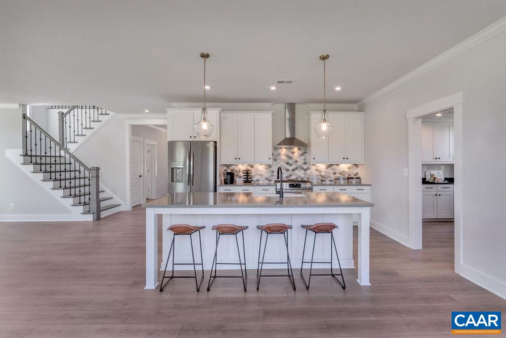 313 Sunbird Lane Waynesboro, VA 22980 - Photo 18 of 45 a kitchen with stainless steel appliances granite countertop a kitchen island hardwood floor and a sink