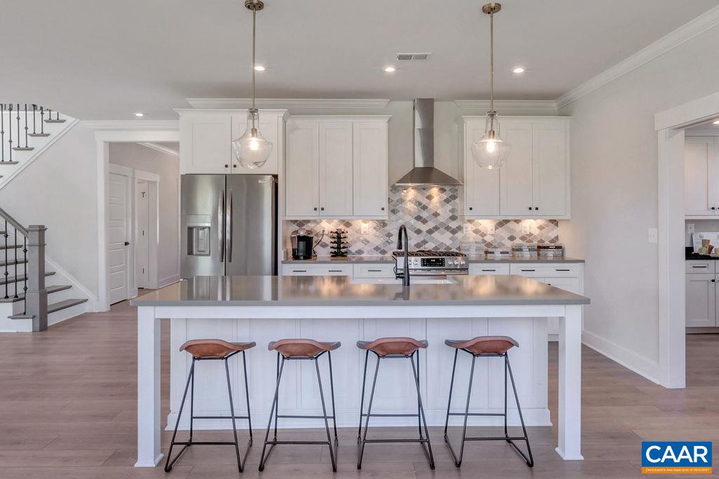 313 Sunbird Lane Waynesboro, VA 22980 - Photo 19 of 45 a kitchen with stainless steel appliances kitchen island granite countertop a dining table chairs and white cabinets