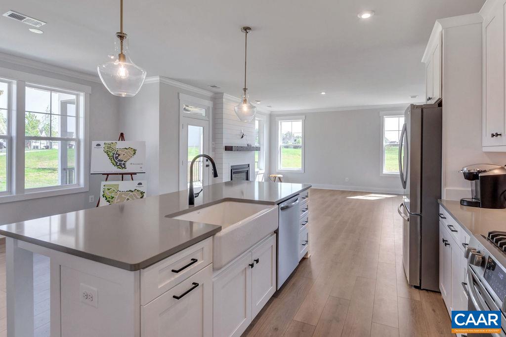 313 Sunbird Lane Waynesboro, VA 22980 - Photo 21 of 45 a kitchen with center island white cabinets and wooden floor