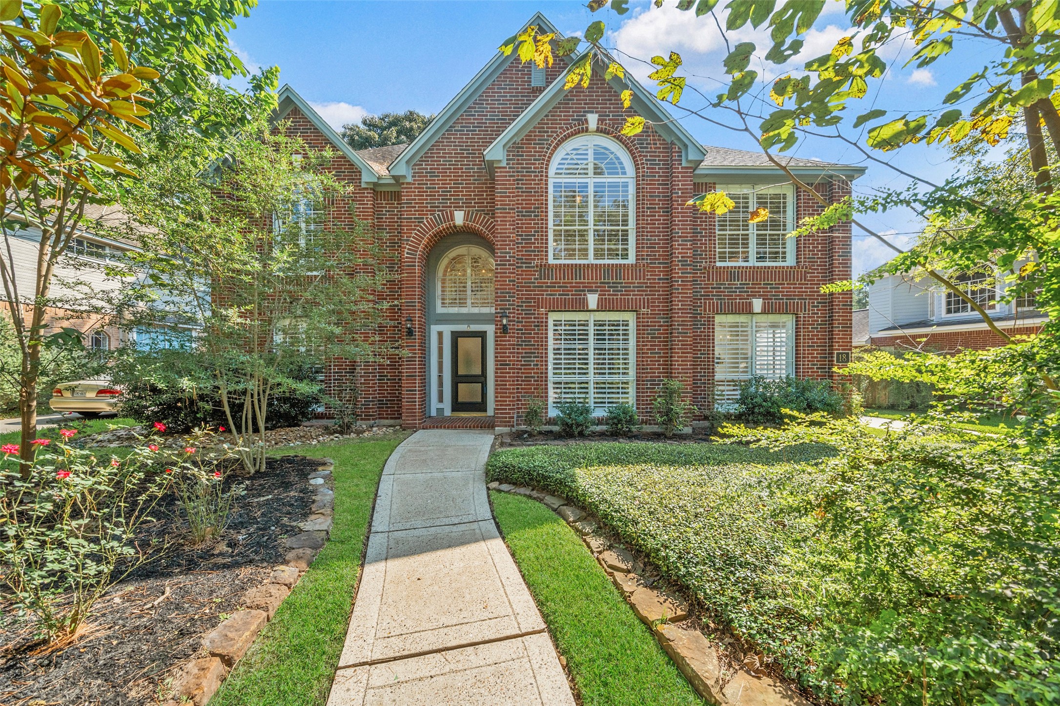 18 South Dragonwood Place Spring, TX 77381 - Photo 1 of 50 a front view of a house with a yard