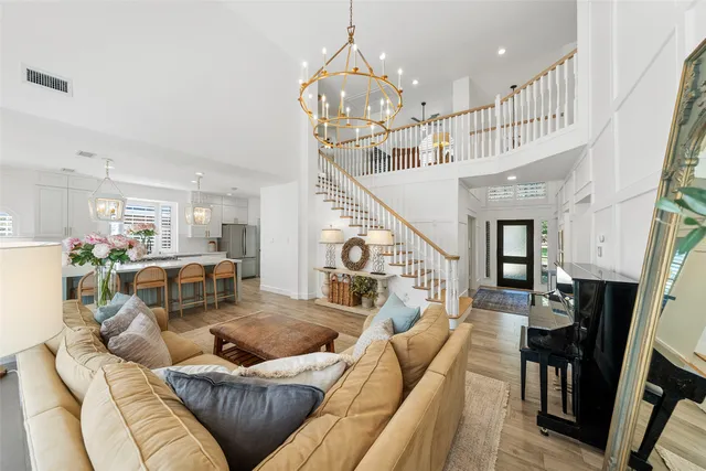 a living room with furniture and a chandelier