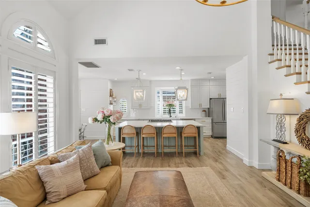 a living room with furniture a dining table and a fireplace