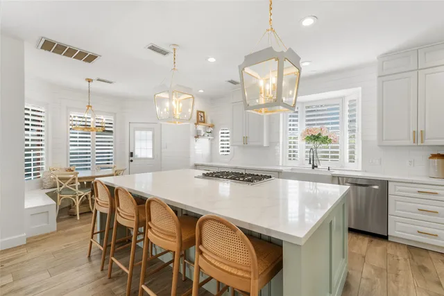 a kitchen with a table chairs and wooden floor