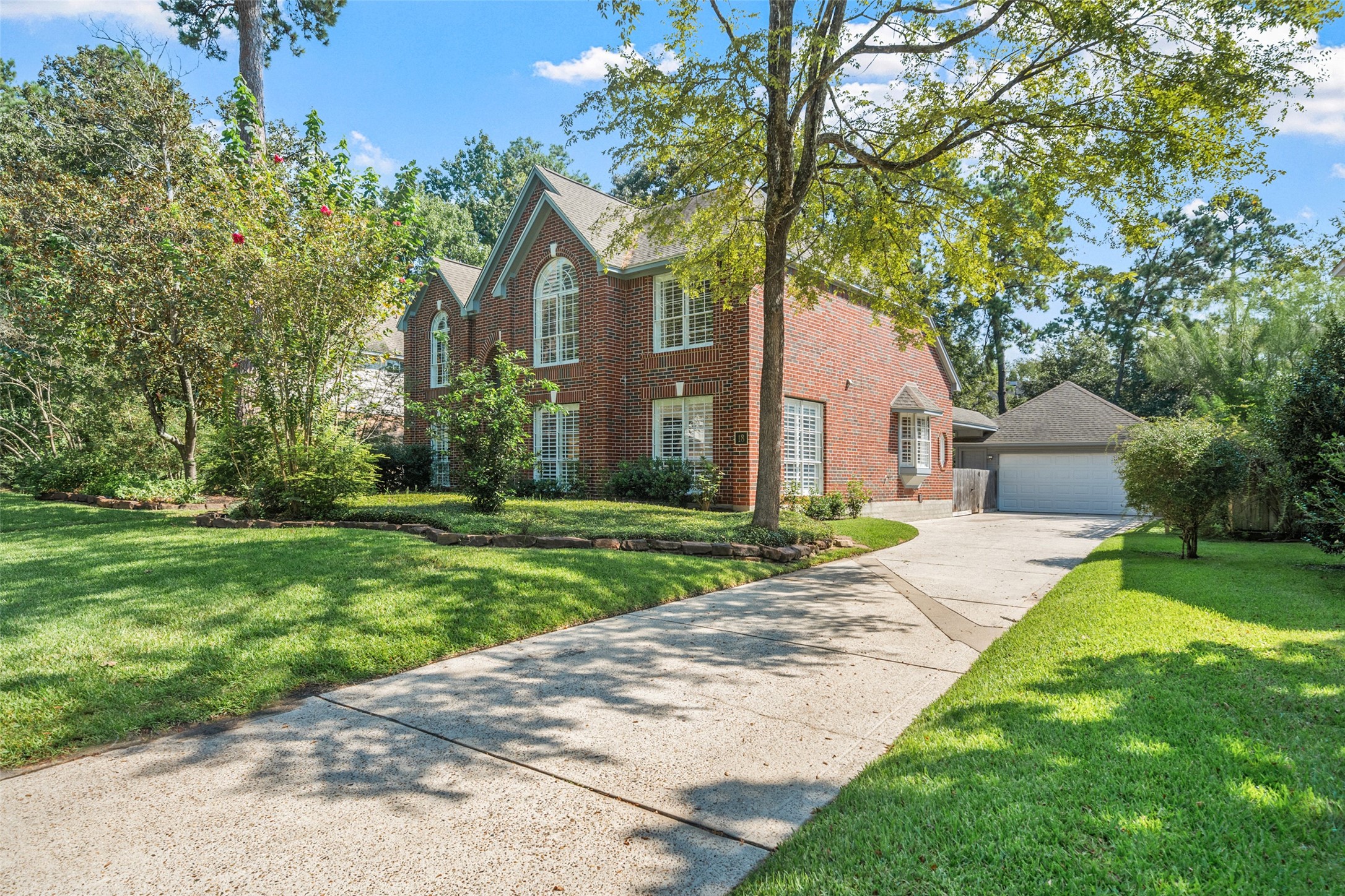 18 South Dragonwood Place Spring, TX 77381 - Photo 2 of 50 a front view of a house with a yard and an trees