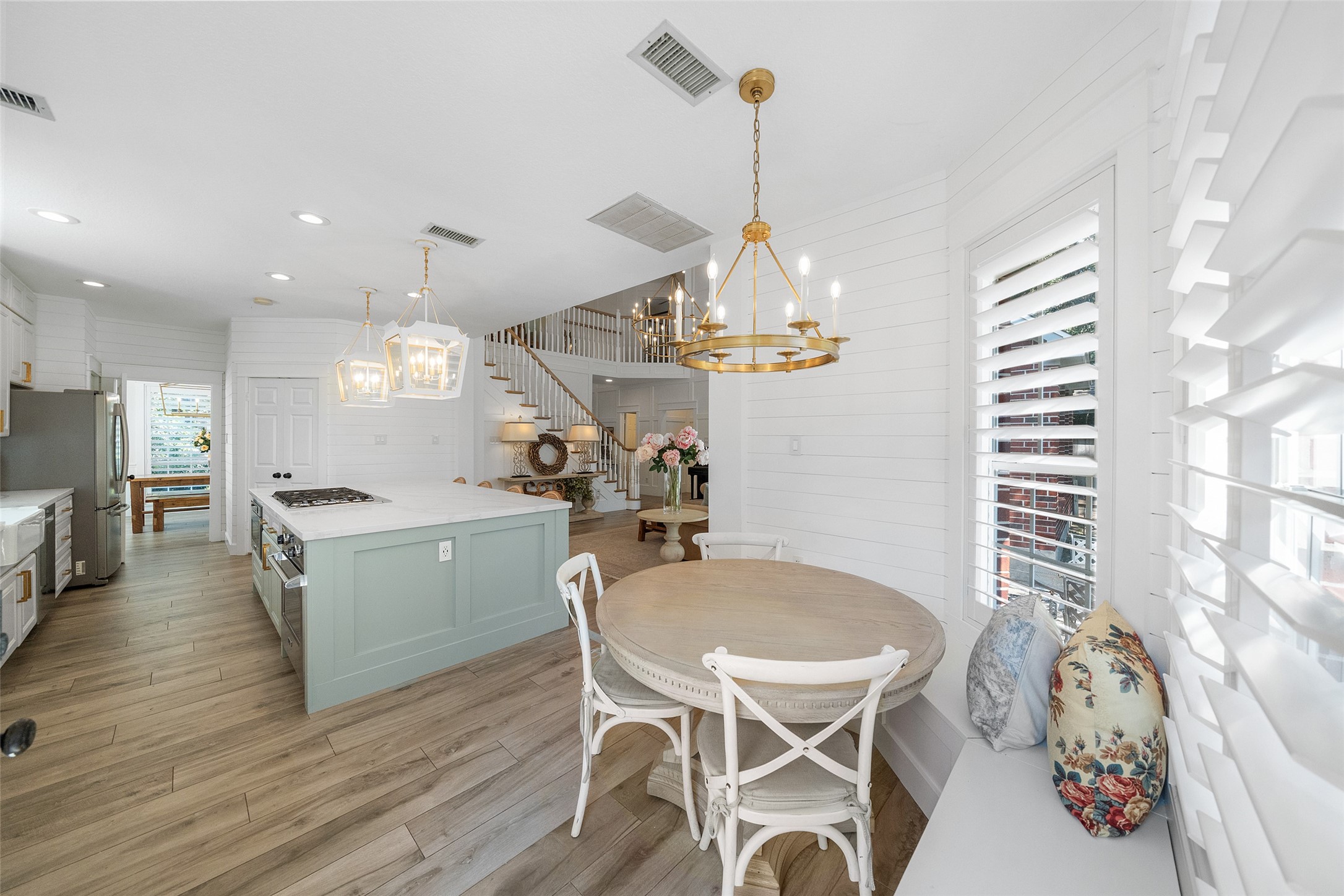 18 South Dragonwood Place Spring, TX 77381 - Photo 25 of 50 a kitchen with a table chairs sink and stove
