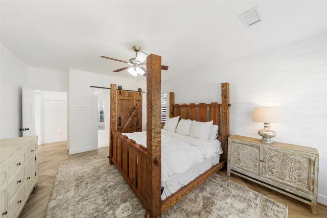 a bathroom with double vanity sinks a large mirror and a bathtub