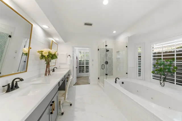 a bathroom with a bathtub a shower and a shower