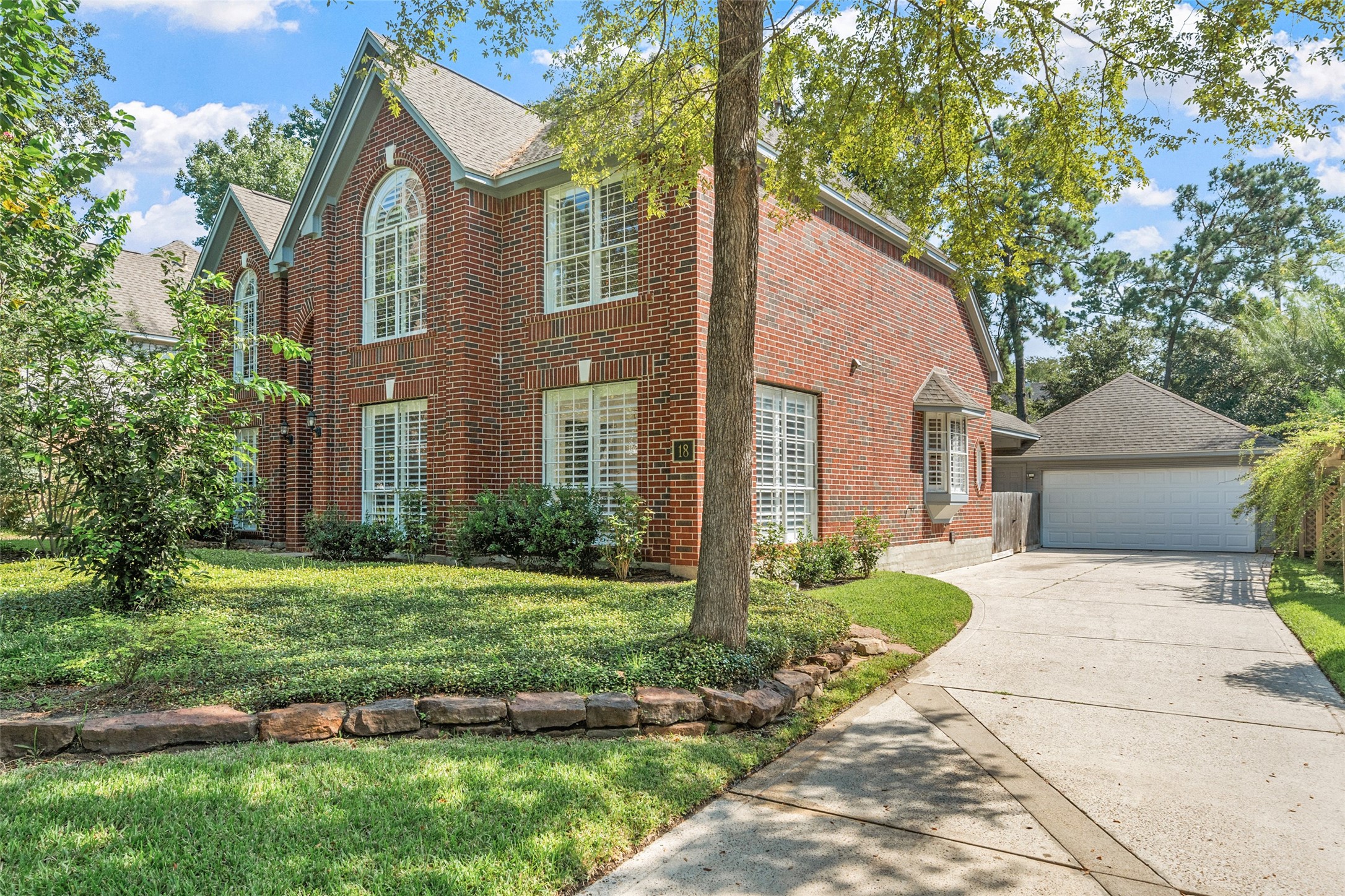 18 South Dragonwood Place Spring, TX 77381 - Photo 3 of 50 a front view of a house with a yard and garage