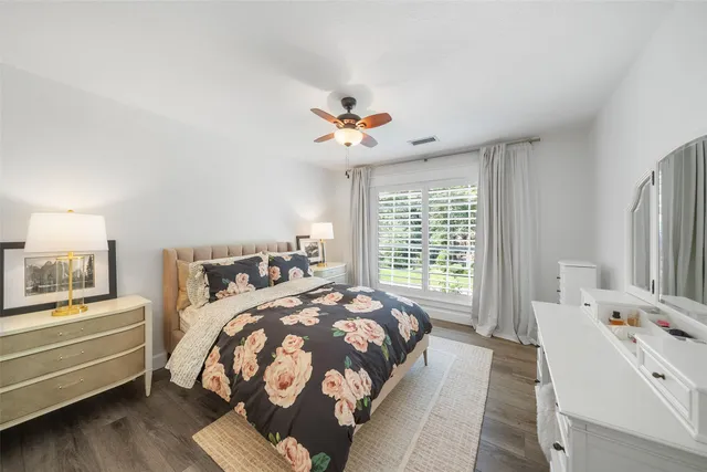 a bedroom with furniture and a large window