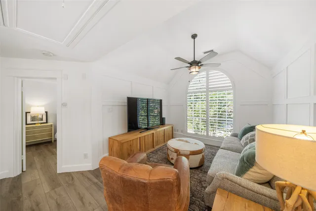 a bedroom with a bed and large window