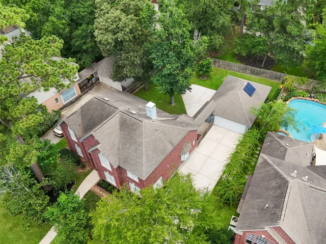 an aerial view of a house with garden space and street view