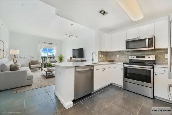 a kitchen with cabinets stainless steel appliances and a counter top space