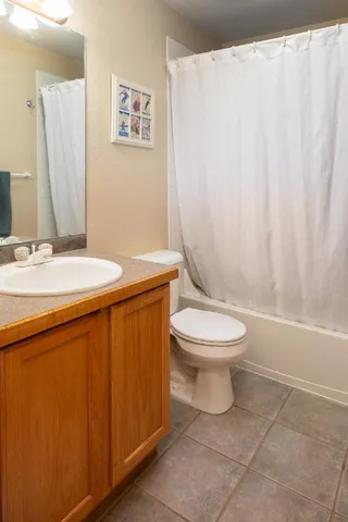 a bathroom with a toilet a sink and a mirror
