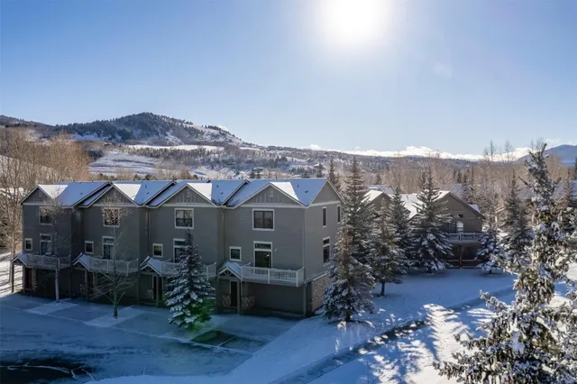 a front view of a house with a tree