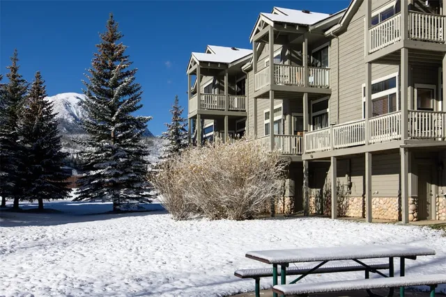 a living room with furniture and a dining table with kitchen view