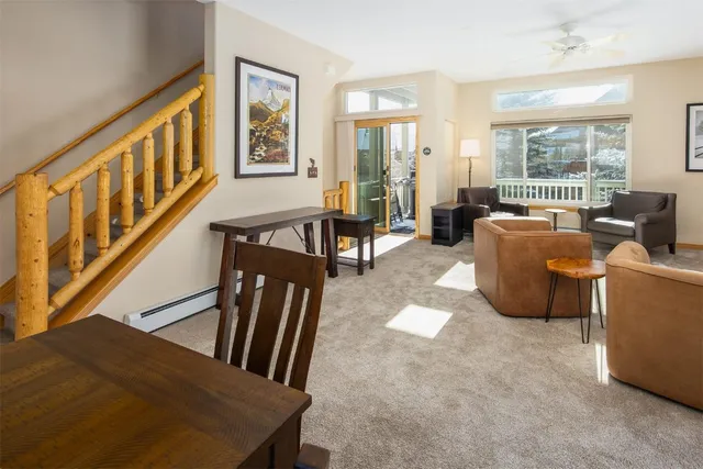 a living room with furniture fireplace and a window