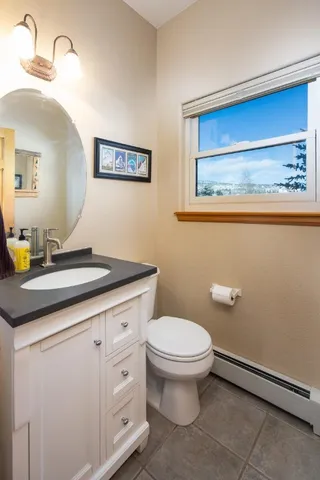 a bathroom with a toilet sink and mirror