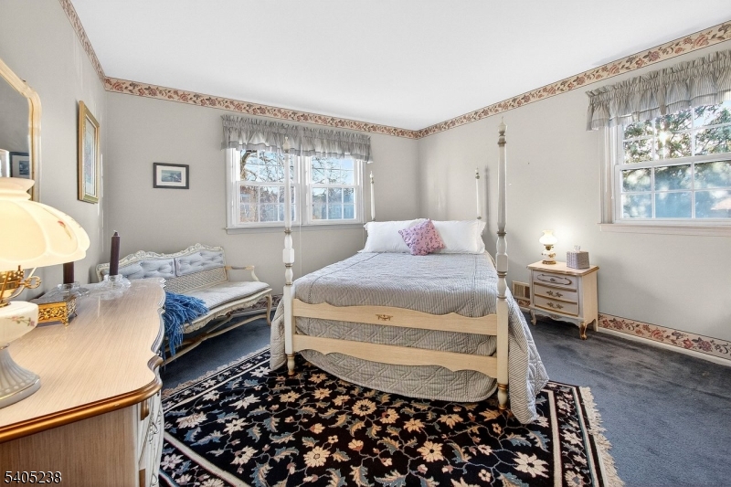 6 Phoenix Drive Mendham, NJ 07945 - Photo 13 of 23 a bedroom with a bed and wooden floor