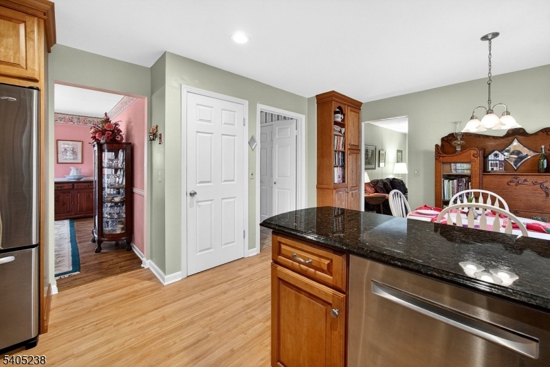 6 Phoenix Drive Mendham, NJ 07945 - Photo 3 of 23 a kitchen with stainless steel appliances granite countertop a sink dishwasher and a stove with wooden floor