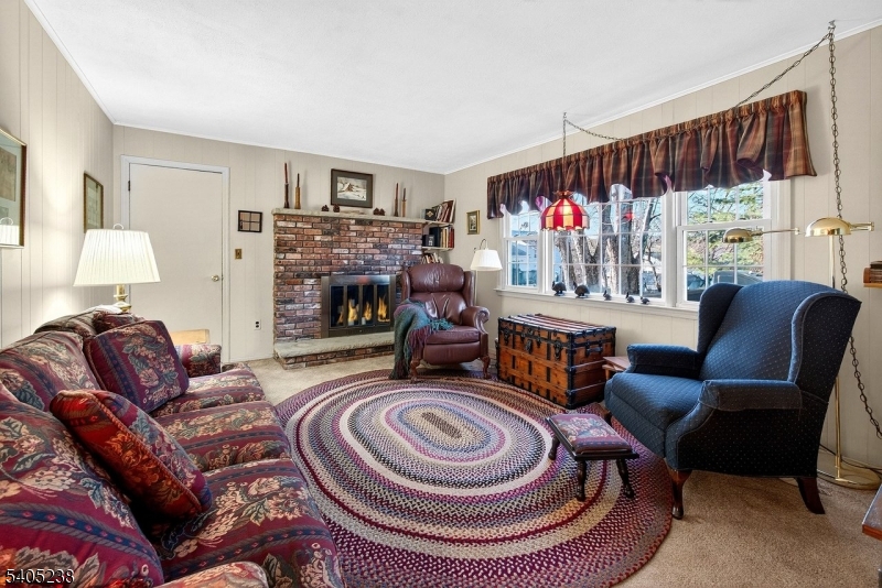 6 Phoenix Drive Mendham, NJ 07945 - Photo 7 of 23 a living room with furniture and a fireplace