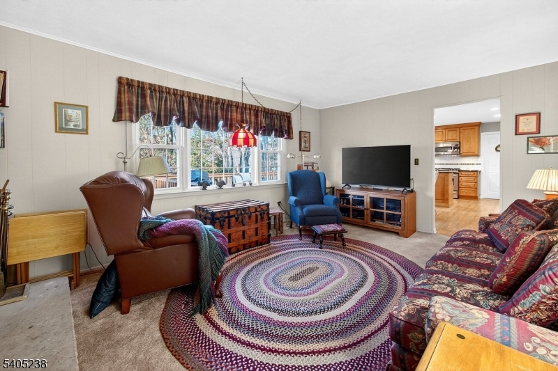 6 Phoenix Drive Mendham, NJ 07945 - Photo 8 of 23 a living room with furniture and a flat screen tv