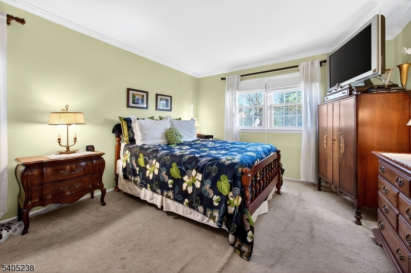 6 Phoenix Drive Mendham, NJ 07945 - Photo 10 of 23 a bedroom with a bed window and a flat screen tv