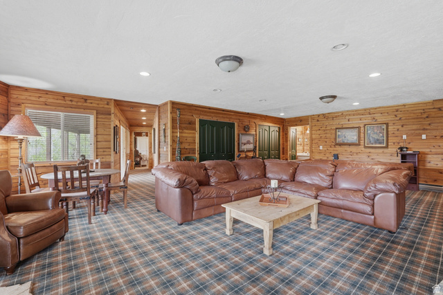6 Beaver Springs Rancheros Oakley, UT 84055 - Photo 32 of 68 Expansive living area featuring plank wood walls, plaid carpet flooring, and recessed lighting