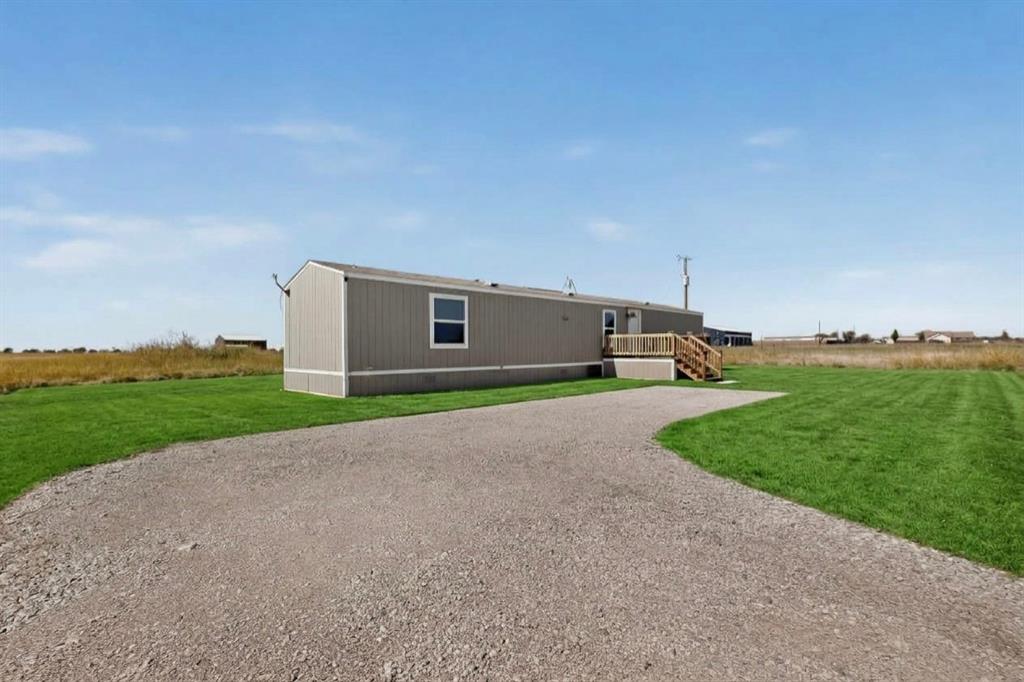 15281 Stice Road Krum, TX 76249 - Photo 1 of 22 Gravel driveway leading to residence with light gray siding