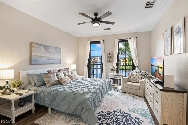 a bedroom with a bed a couch and a large window