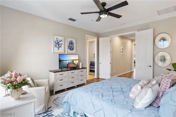 a bedroom with a bed and a chandelier