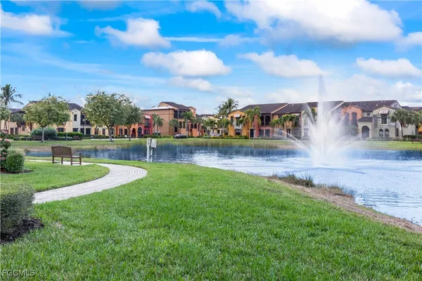 a view of a park with houses lake and mountain in the back