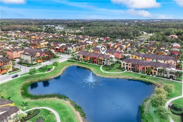 an aerial view of a residential houses with outdoor space and river