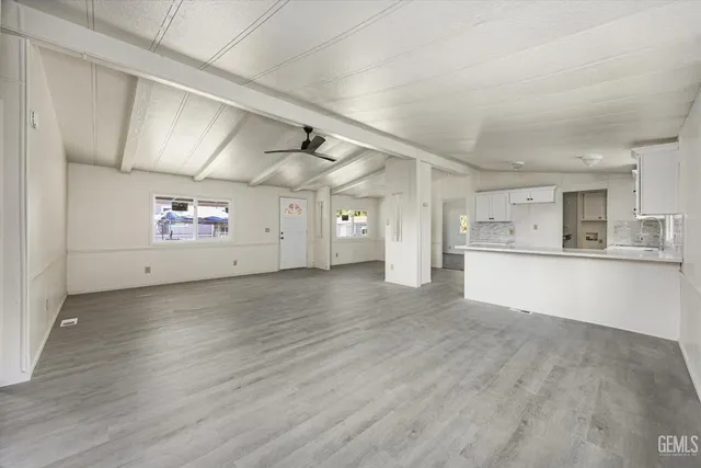 a view of a kitchen with a sink and a refrigerator