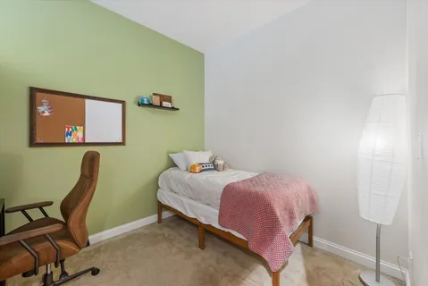 a bedroom with a bed and a chair
