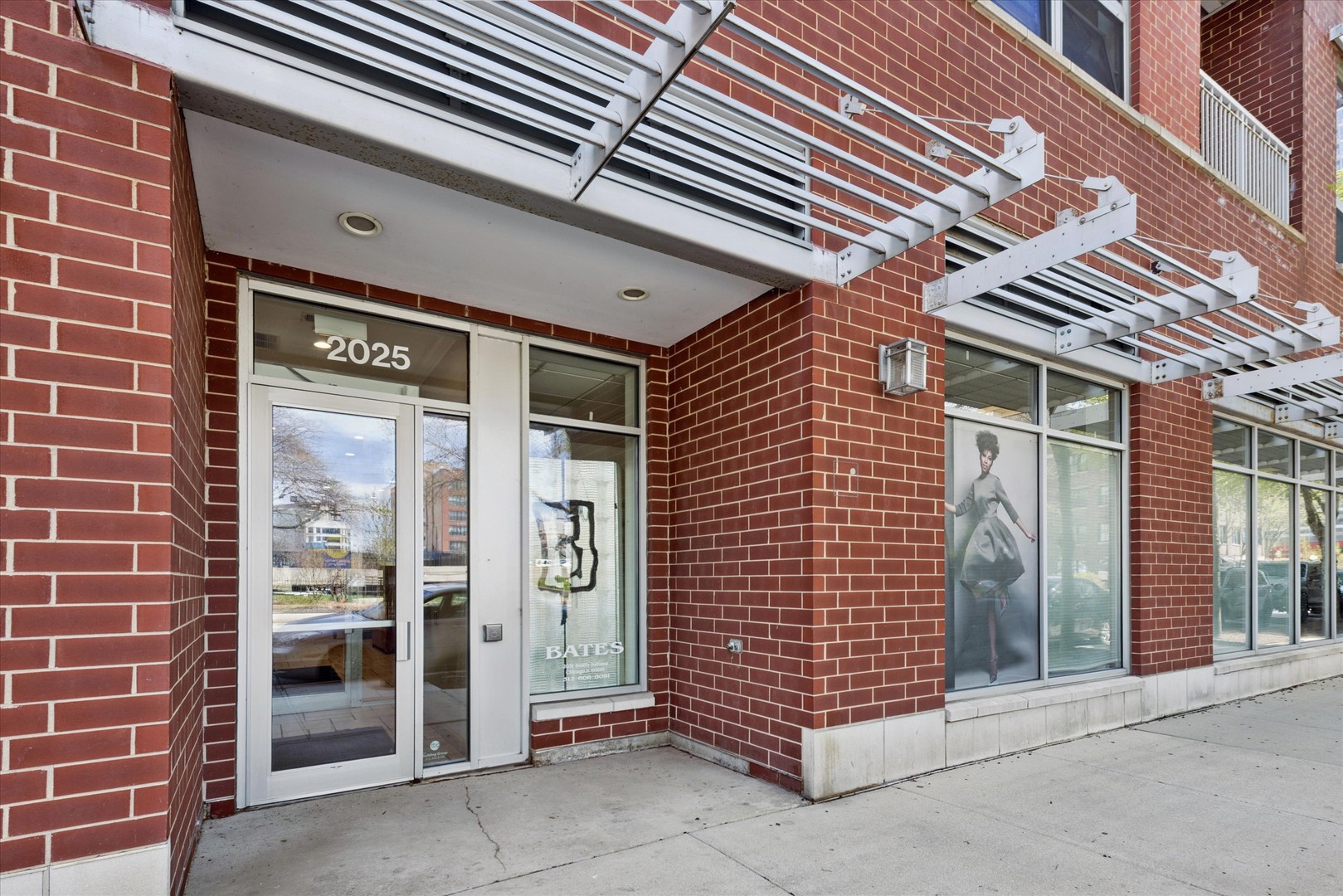 2025 South Indiana Avenue, Unit 209 Chicago, IL 60616 - Photo 2 of 17 a front view of a building with glass door
