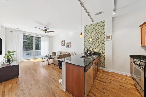 a kitchen with stainless steel appliances granite countertop a stove and wooden floor