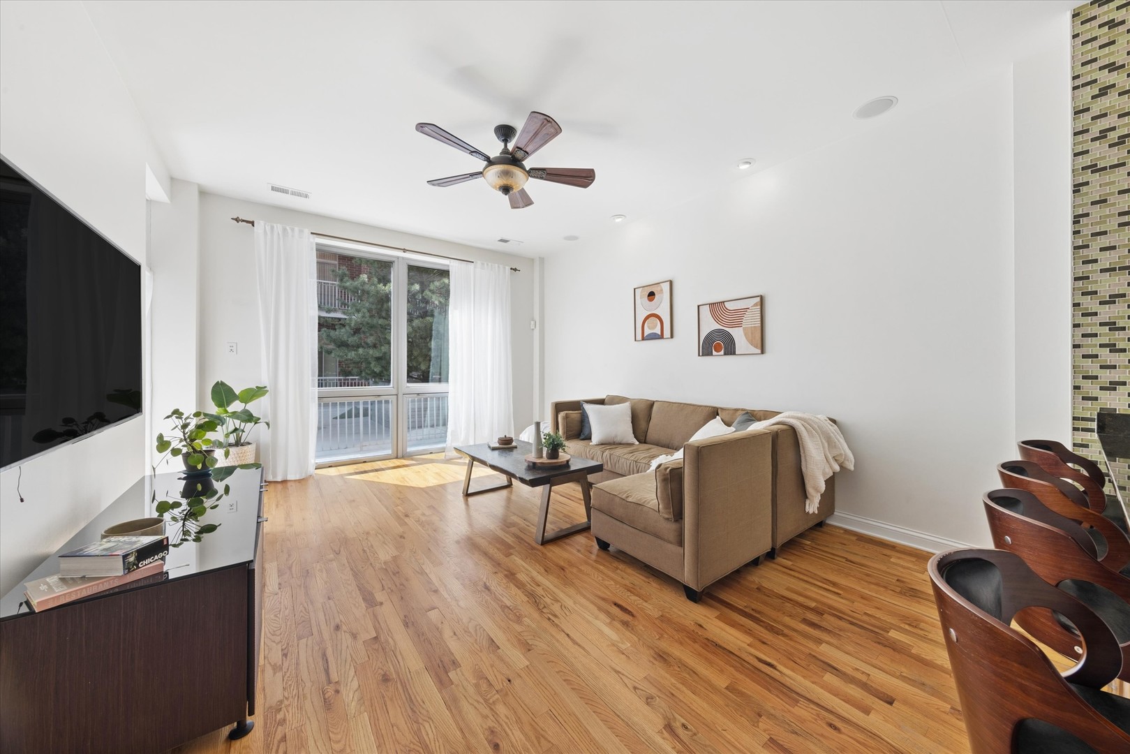 2025 South Indiana Avenue, Unit 209 Chicago, IL 60616 - Photo 5 of 17 a living room with furniture and a flat screen tv