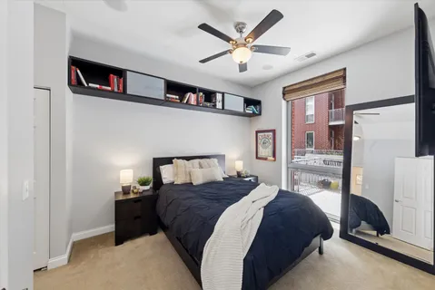 a bedroom with a bed cabinets and a walk in closet