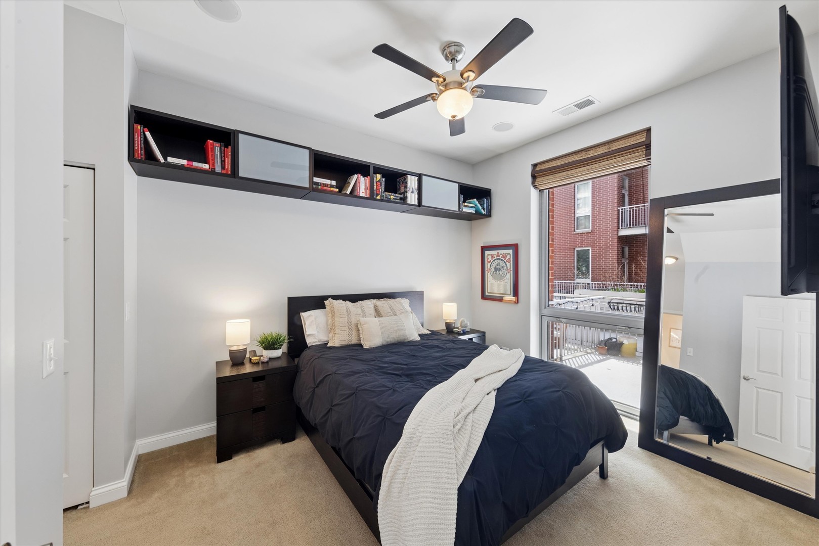 2025 South Indiana Avenue, Unit 209 Chicago, IL 60616 - Photo 9 of 17 a bedroom with a bed cabinets and a walk in closet