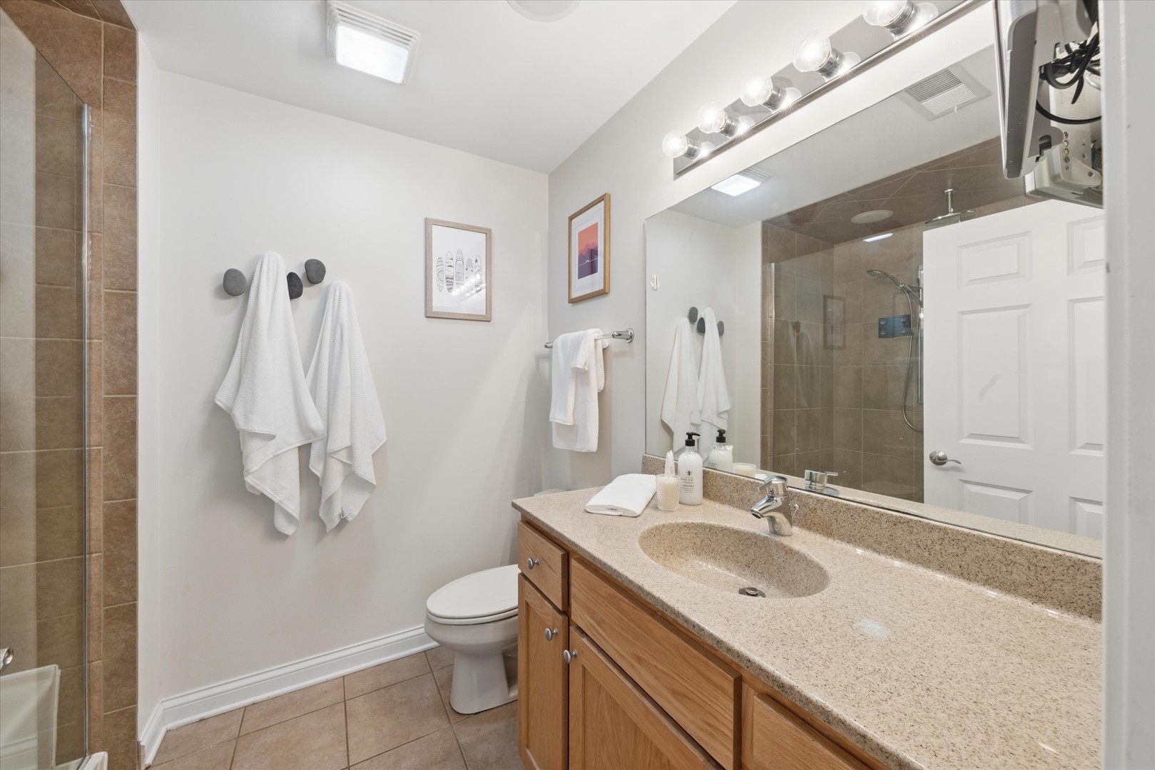 2025 South Indiana Avenue, Unit 209 Chicago, IL 60616 - Photo 10 of 17 a bathroom with a granite countertop sink a toilet and a mirror